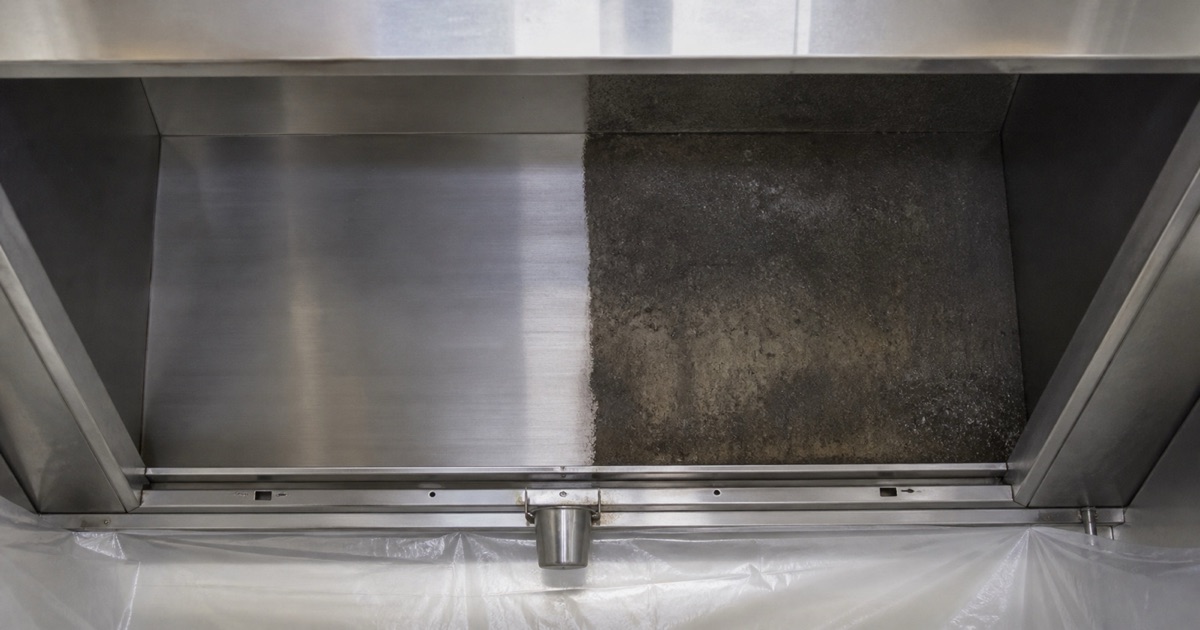 A hood interior half cleaned to bare metal and half still coated,